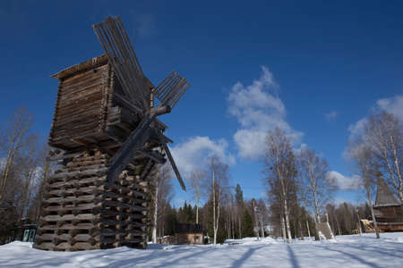 winter snow shot of russian wooden traditional windmill in the northern open air museum Malye Korely near Arkhanglesk, Primorsk Region, Russiaのeditorial素材