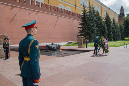 MOSCOW / RUSSIA: 07/01/2021 Sea and River Fleet Worker's Day. Wreath-laying ceremony at Tomb of the Unknown Soldier in Alexander garden. Young soldier from back, seamen putting a floral offeringのeditorial素材