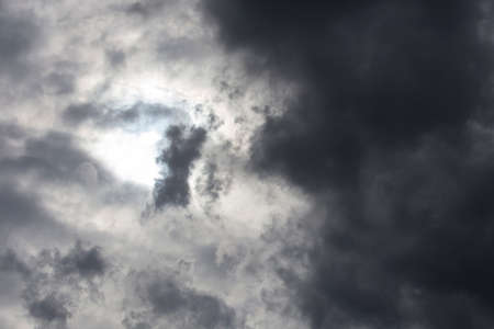 beautiful day cloudscape view from below of dramatic dramatic gray and white thunder storm clouds on a dark sky backgroundの写真素材