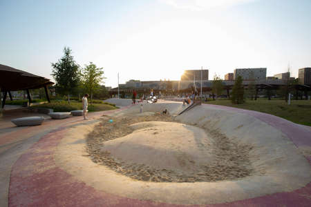 Moscow, Russia - 08.08.2021. Children playground with skate cradle, sandbox, tubes, slide, pergola, buildings. Tyufeleva Roshcha park, Zilart. ! melk landscape architecture urban designのeditorial素材
