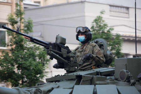 Moscow, Russia - 18.06.2020 Victory Day Parade rehearsal. Tankman soldier on a gun turret of a Russian army military armored vehicle tank at Sadovaya street (garden Ring)のeditorial素材