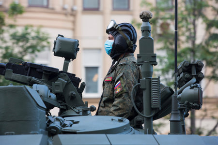 Moscow, Russia - 18.06.2020 Victory Day Parade rehearsal. Tankman soldier on a gun turret of a Russian army military armored vehicle tank at Sadovaya street (garden Ring)のeditorial素材