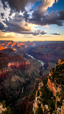 Majestic Grand Canyon landscape with dramatic sunset sky and river flowing below. Awe inspiring scenic view from Arizona national parkの素材