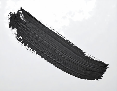 A bold black paint brushstroke shows an abstract artistic texture. creative design element on an isolated white background for modern projectの素材