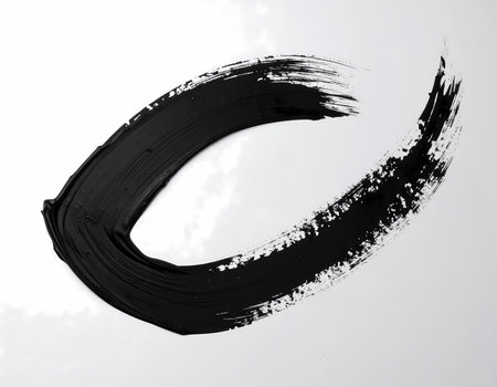 A minimalist black ink enso circle brush stroke on white background. an abstract, artistic japanese calligraphy drawing symbolizing minimalismの素材