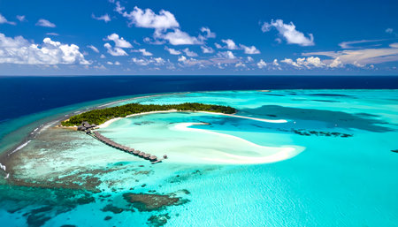 A serene aerial view of tropical island paradise in blue ocean. beautiful turquoise lagoon surrounds white sand beach and coral reef, creating peaceful and tranquil sceneの素材