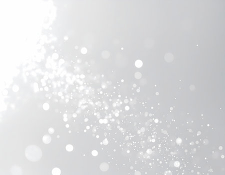 A magical abstract background with white sparkle and glowing particle light. silver bokeh glitter effect on soft gray backdrop for designの素材