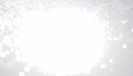 Wondrous abstract background featuring glowing white light, shimmering glitter, and elegant sparkle. This shiny, unfocused bokeh creates magical feeling for celebrationの素材