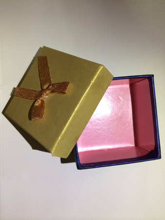 Opened golden blue gift box with pink interior