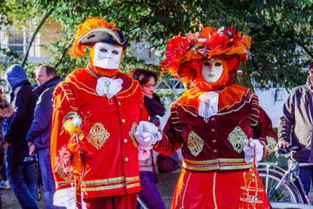 Bruges, Belgium 17 January 2016: Couple of people dressed in Venetian costumes and masks in a Carnival show in the city of Bruges, Belgium.のeditorial素材
