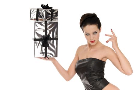 Sexy woman in black leather corset with silver Christmas gifts isolated on white backgroundの写真素材