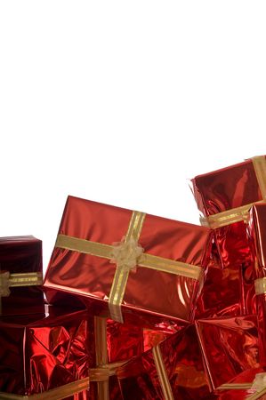 Pile of Christmas presents wrapped in red foil on white backgroundの写真素材