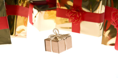 Simple present isolated on white background surrounded by glossy wrapped presents