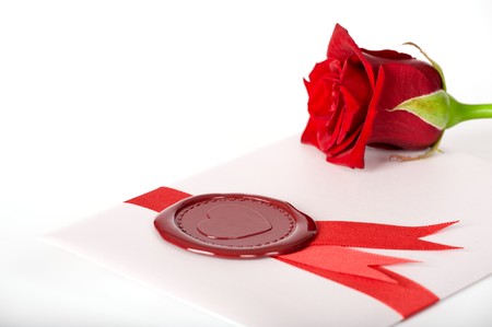 Valentine card with red rose and seal on white backgroundの写真素材