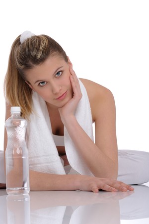 Young fitness woman with bottle of water on white backgroundの写真素材