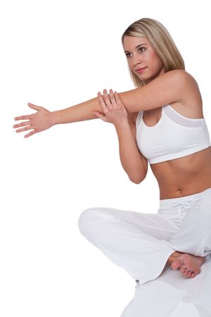 Young woman stretching on white backgroundの写真素材