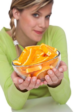 Woman holding bowl with oranges on white background, focus on orangeの写真素材