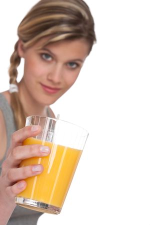 Healthy lifestyle series - Woman with glass of orange juice on white background, focus on handの写真素材