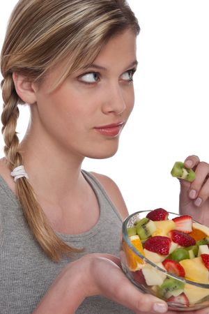 Healthy lifestyle series - Woman with fruit salad on white backgroundの写真素材