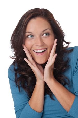Surprised young woman with turquoise vest on white backgroundの写真素材