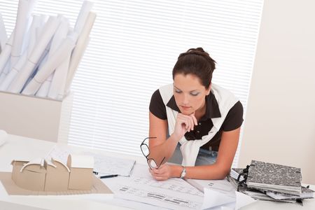 Young female architect with plans at the officeの写真素材