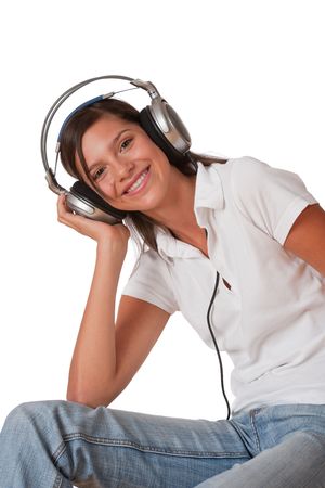 Teenager with closed eyes listening to music with headphones on white backgroundの写真素材