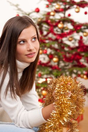 Young woman with Christmas decoration at homeの写真素材