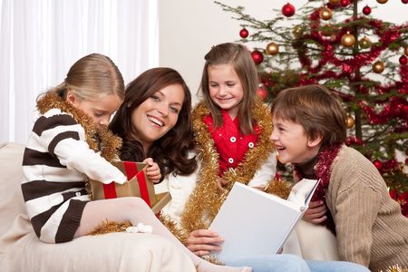 Happy family: mother with three children on Christmasの写真素材