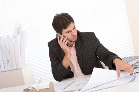 Young businessman on the phone at officeの写真素材