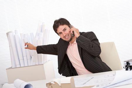 Young businessman on the phone at officeの写真素材
