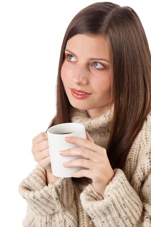 Winter portrait of happy woman holding cup of coffee wearing turtleneck on whiteの写真素材