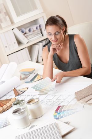 Female interior designer working at office with color swatch choosing colorの写真素材