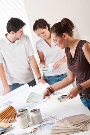Female interior designer with two clients at office choosing colorsの写真素材
