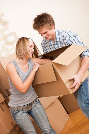 New house: Young couple moving box, unpacking in new homeの写真素材