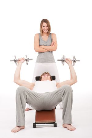 Fitness - young man exercising on bench on white backgroundの写真素材