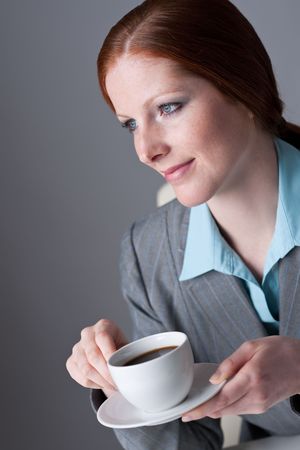 Successful business woman having coffee break at officeの写真素材