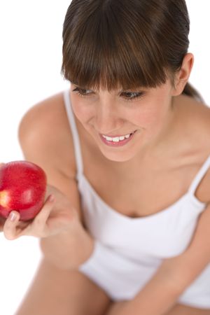 Female teenager eat apple for breakfast on white backgroundの写真素材
