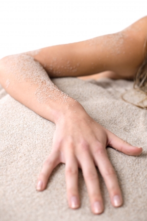 Beach - Part of female body, hand  covered with sandの写真素材