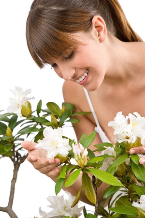 Gardening - Portrait of woman with Rhododendron flower on white backgroundの写真素材