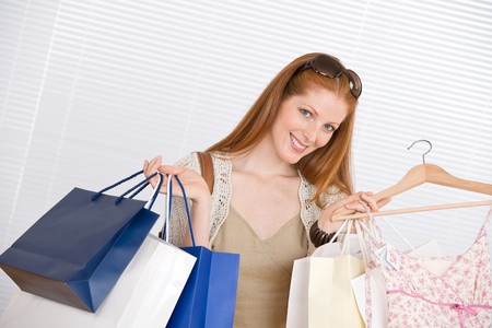 Fashion shopping - Happy woman with bag and sale dressの写真素材
