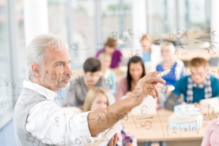 Math lesson at high school - students with professor in classroomの写真素材