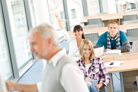 High school - three students with mature professor in classroomの写真素材