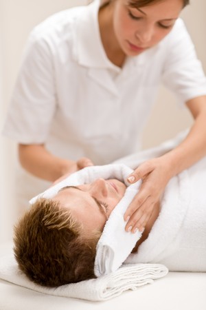 Male cosmetics - luxury spa treatment receiving facial massageの写真素材