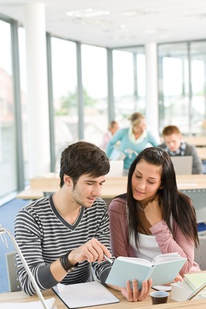 High school - two students read book in classroomの写真素材