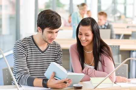 High school - two students read book in classroomの写真素材