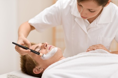 Male cosmetics - facial mask in luxury spa centerの写真素材