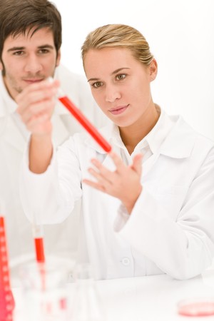 Scientists in laboratory - flu virus test tube with red liquidの写真素材