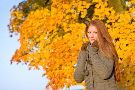 Autumn sunset park - red hair woman fashion in natureの写真素材