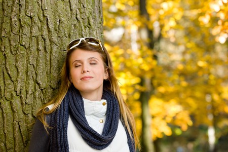 Autumn park - fashion woman with sunglasses on sunny dayの写真素材