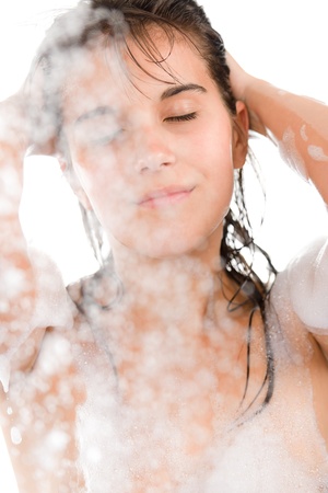 Young woman enjoy shower on white backgroundの写真素材
